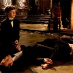 A young Bruce Wayne is forced to watch his parents die
